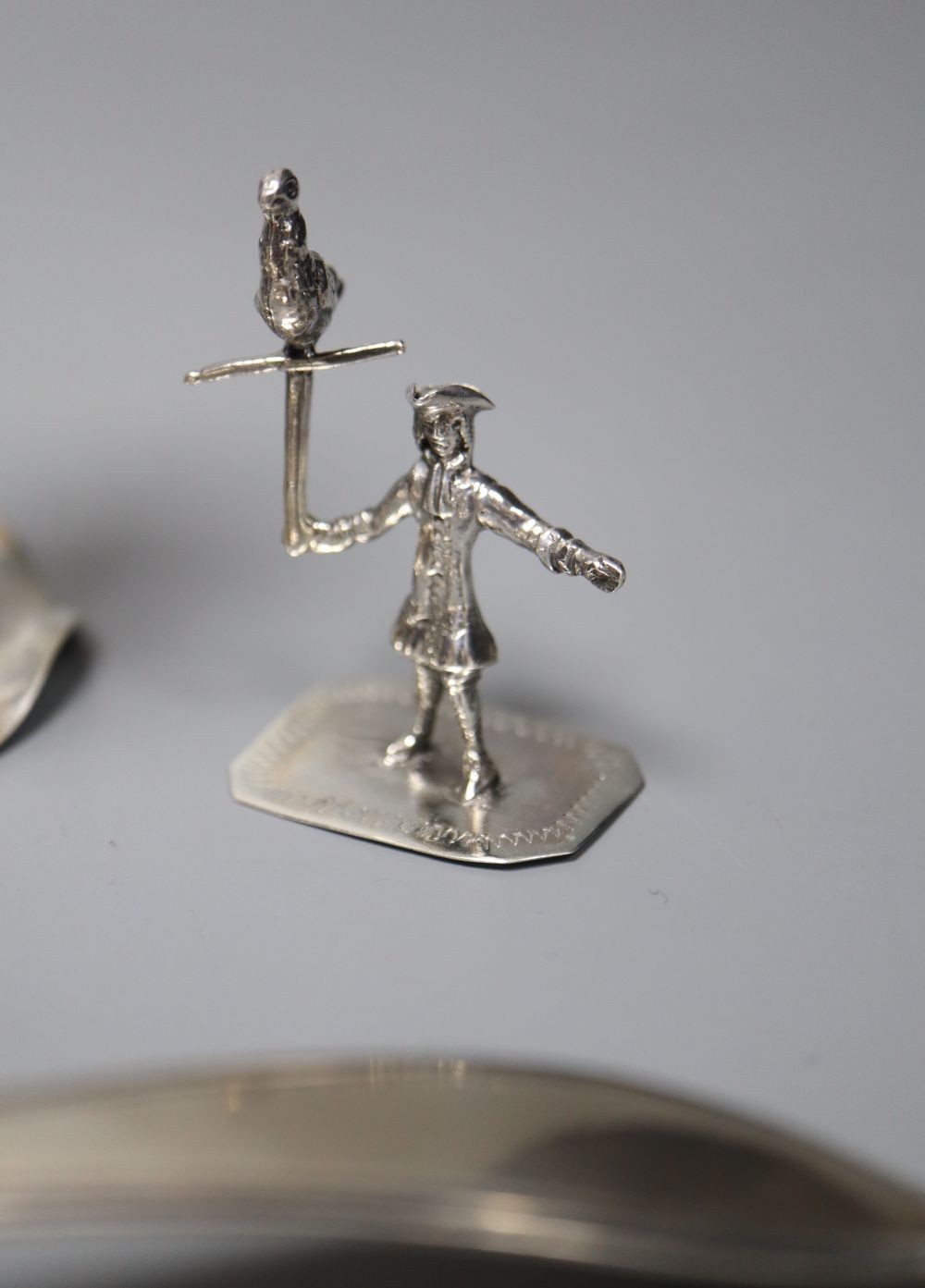 Two Dutch white metal sifter spoons, a Chinese white metal vase (base missing0 and two toy items, Dutch & Chinese.